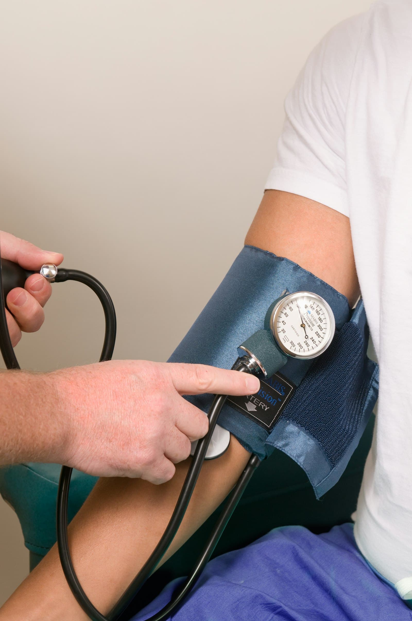 A clinician checking a patient's blood pressure