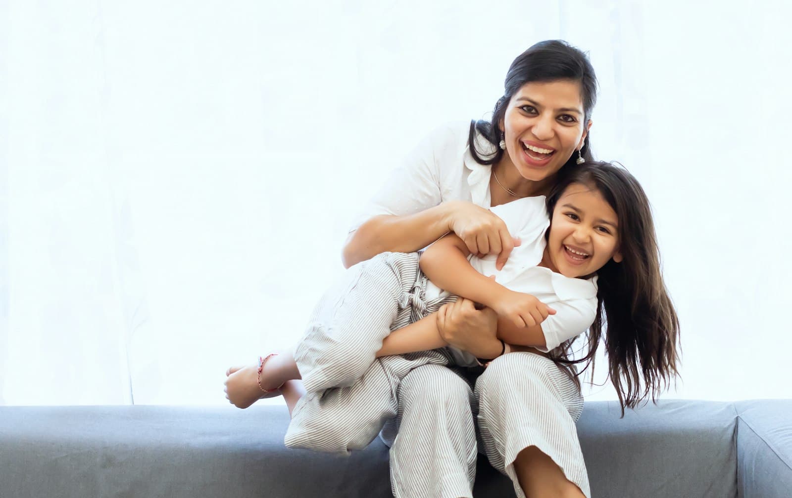 A mother holding her laughing child