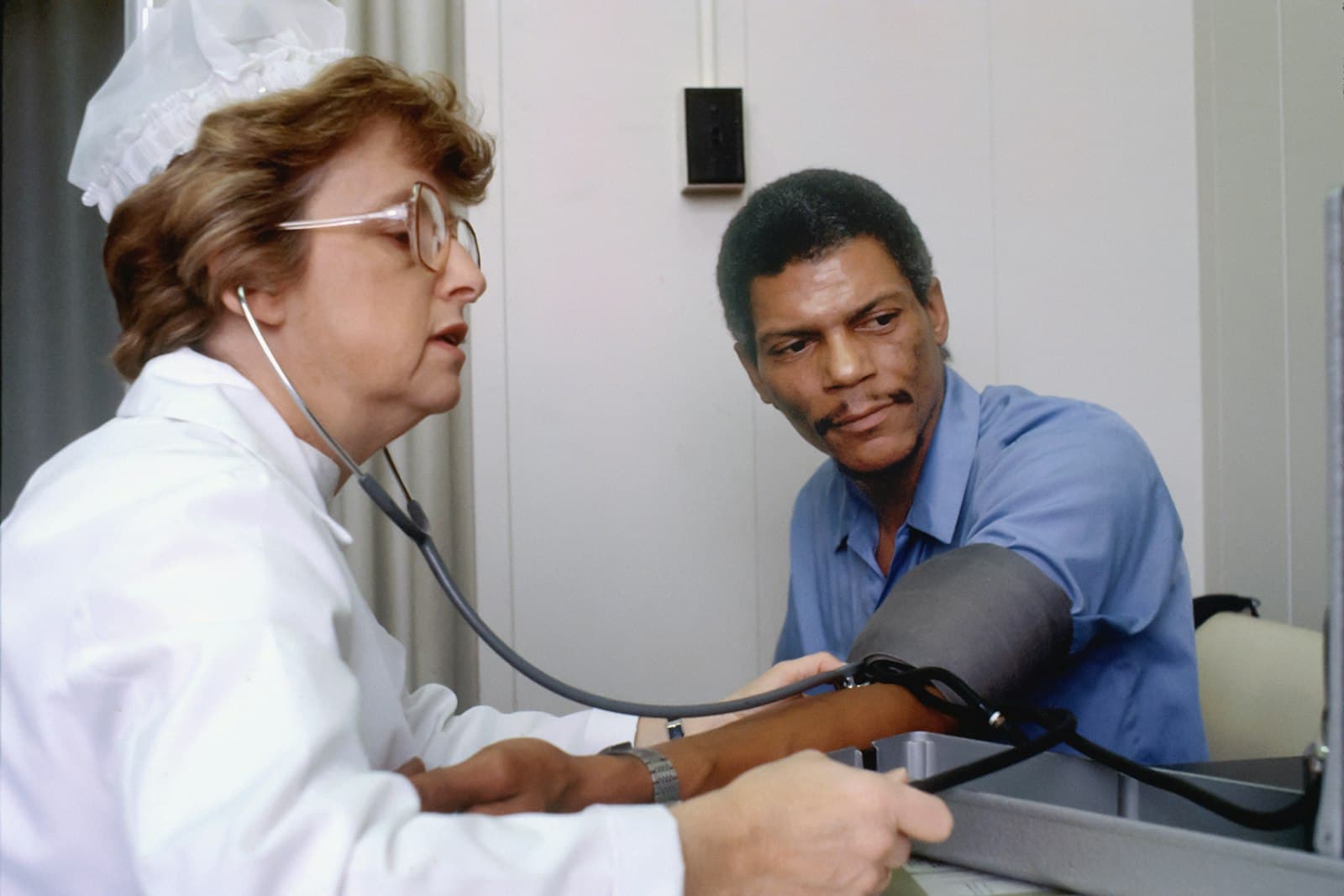 A clinician talking with a patient during a check-up