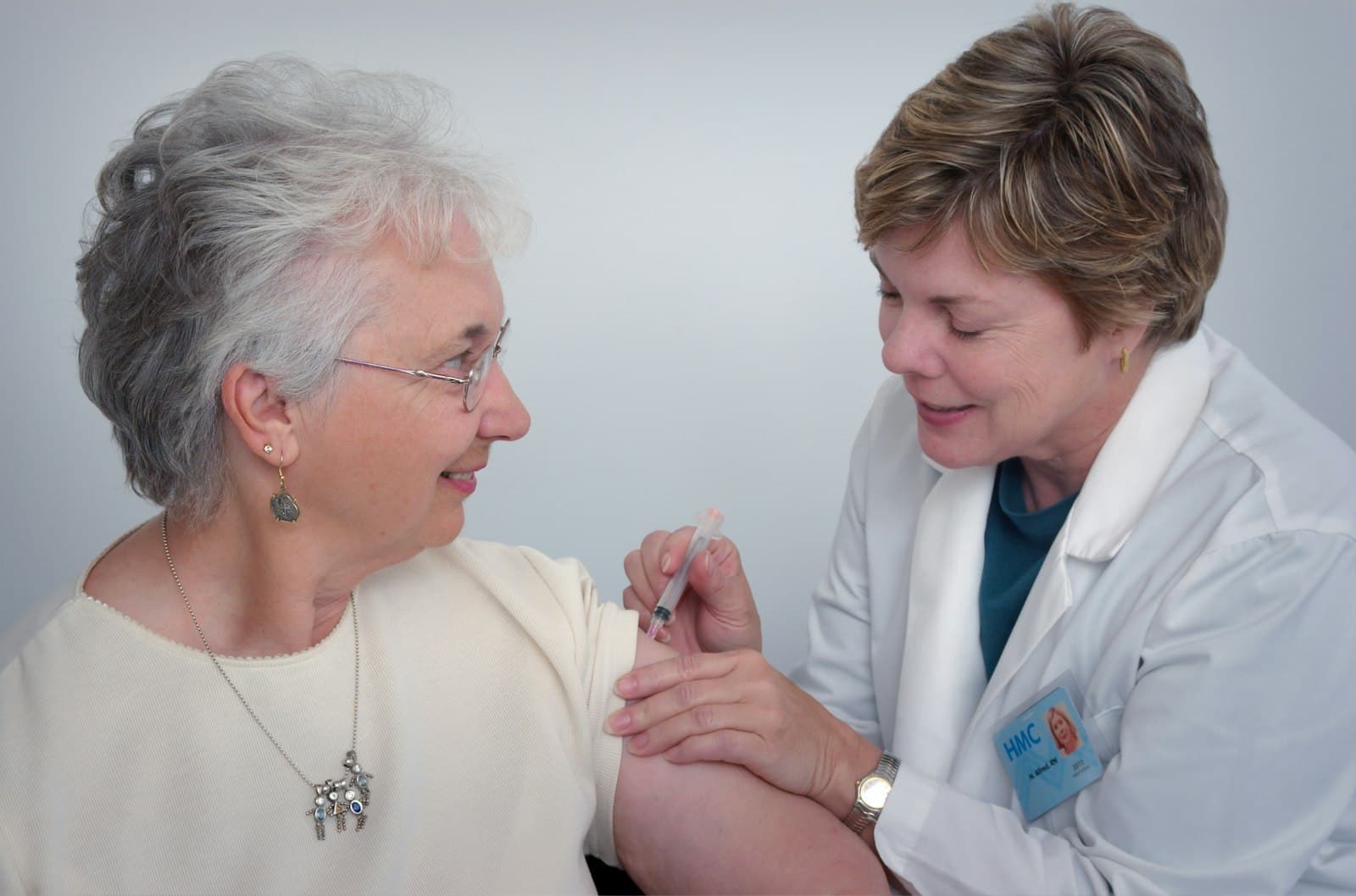 A woman receiving a vaccine in her arm