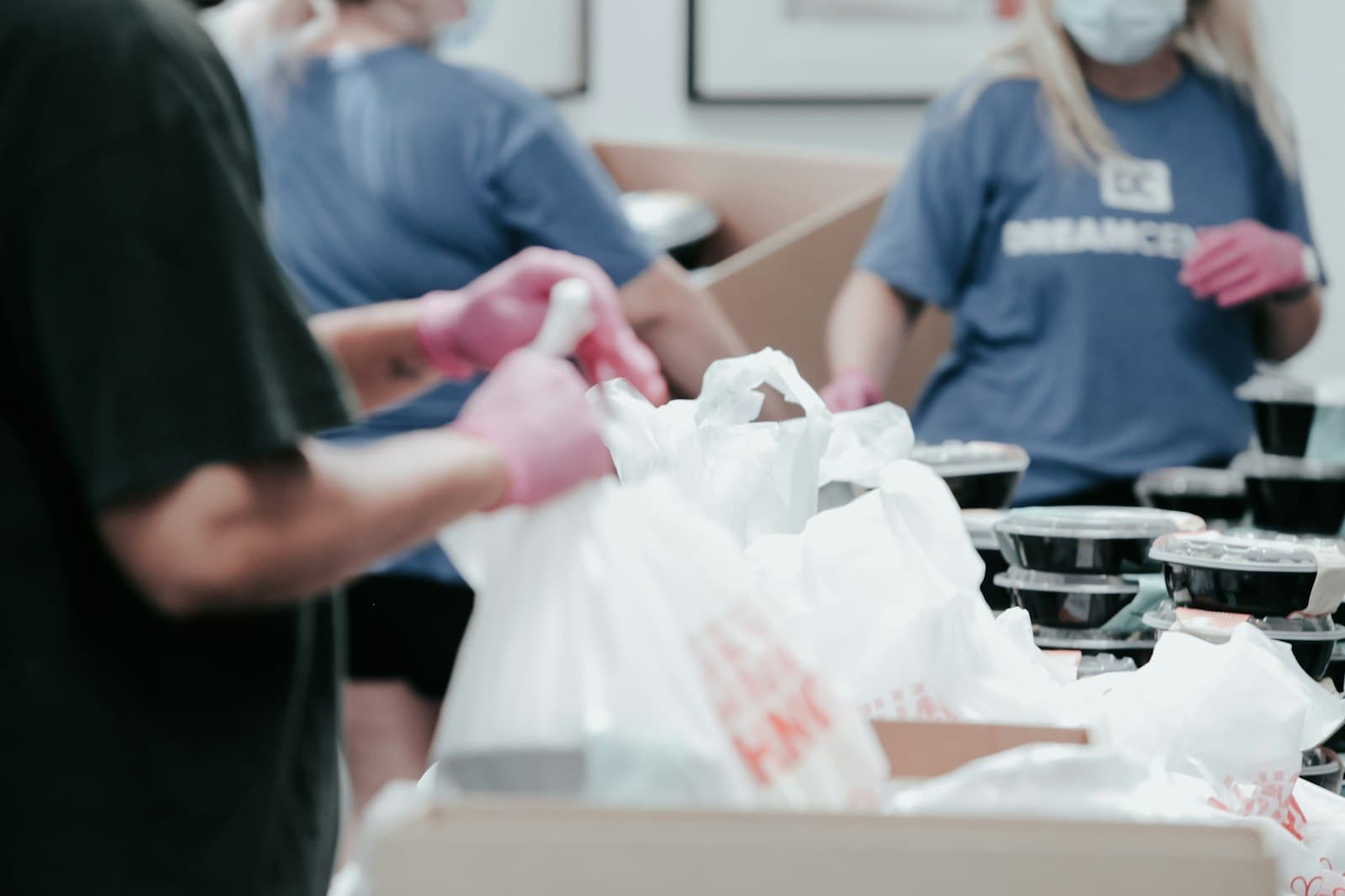 Volunteers packing bags of supplies